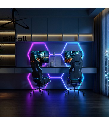 Hexagon RGBIC paneler monteret på væggen i et gaming setup med kraftig farveintensitet.